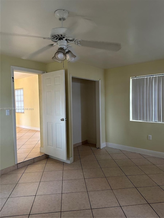 658 SE 8th Pl, Hialeah, FL 33010 - unfurnished bedroom with light tile patterned floors, a closet, and ceiling fan