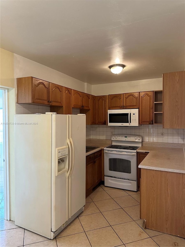 658 SE 8th Pl, Hialeah, FL 33010 - kitchen featuring white appliances, open shelves, light tile patterned flooring, and brown cabinets