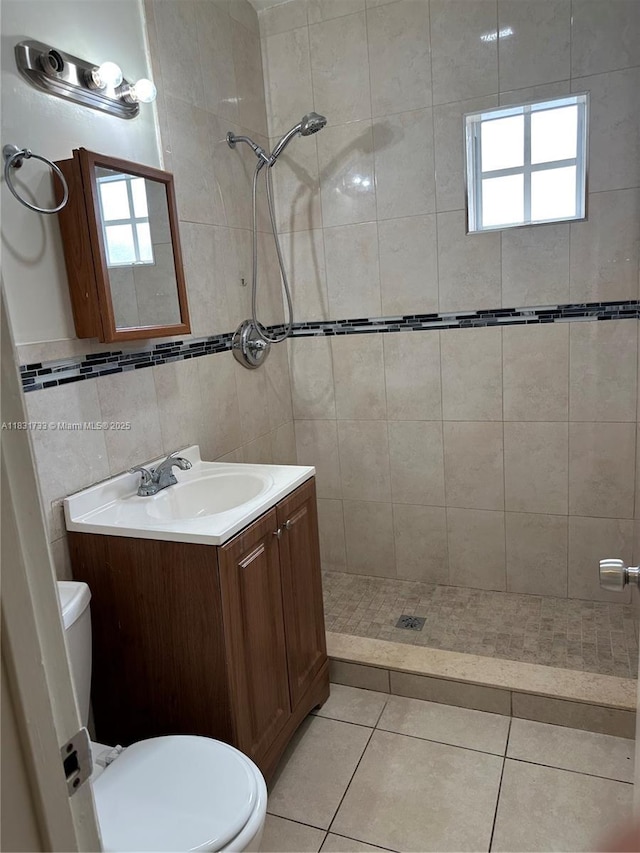 658 SE 8th Pl, Hialeah, FL 33010 - bathroom with a stall shower, vanity, tile patterned flooring, plenty of natural light, and tile walls
