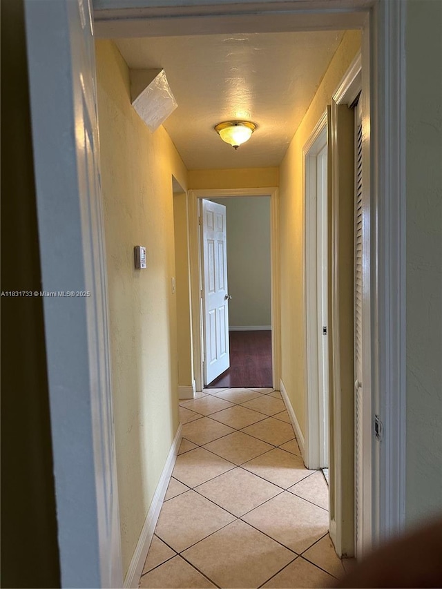 658 SE 8th Pl, Hialeah, FL 33010 - hallway with light tile patterned floors and baseboards