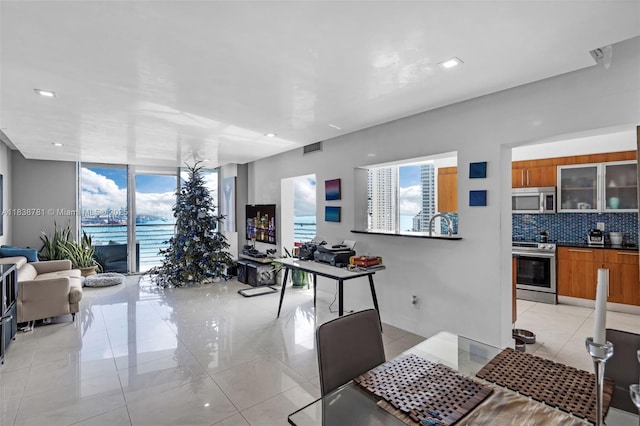 325 S Biscayne Blvd Unit 1823, Miami, FL 33131 - dining room with healthy amount of natural light, light tile patterned floors, expansive windows, and recessed lighting
