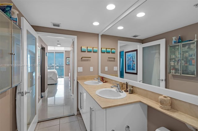 325 S Biscayne Blvd Unit 1823, Miami, FL 33131 - full bathroom with tile patterned flooring, double vanity, connected bathroom, and recessed lighting