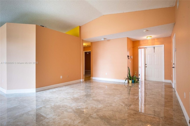 14677 SW 123rd Ave, Miami, FL 33186 - empty room featuring lofted ceiling, marble finish floors, a textured ceiling, and a smoke detector