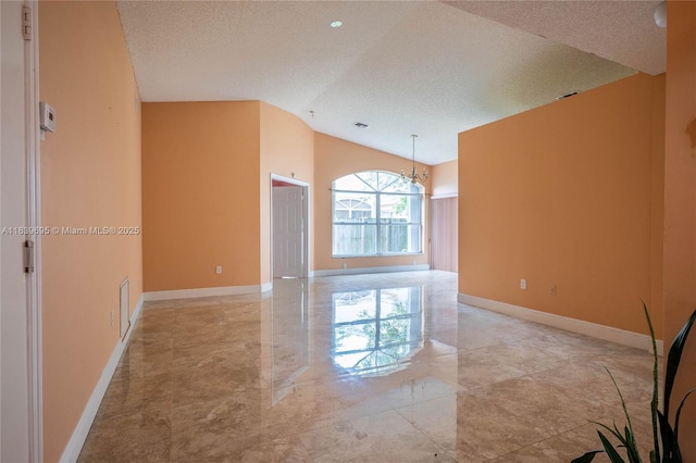14677 SW 123rd Ave, Miami, FL 33186 - unfurnished room featuring a textured ceiling, lofted ceiling, marble tiled flooring, and a chandelier