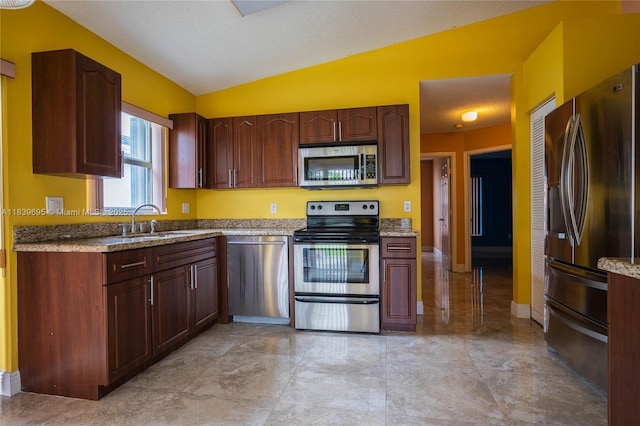14677 SW 123rd Ave, Miami, FL 33186 - kitchen with appliances with stainless steel finishes, vaulted ceiling, and light stone countertops