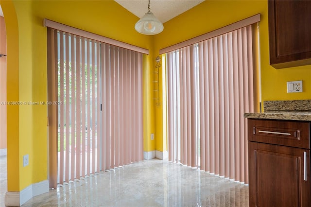 14677 SW 123rd Ave, Miami, FL 33186 - unfurnished dining area with arched walkways and baseboards