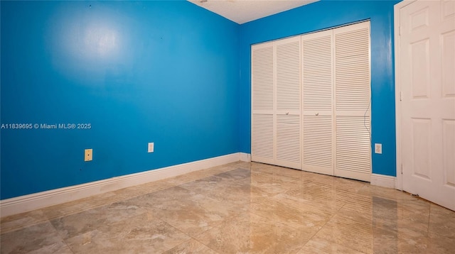 14677 SW 123rd Ave, Miami, FL 33186 - unfurnished bedroom with baseboards and a closet