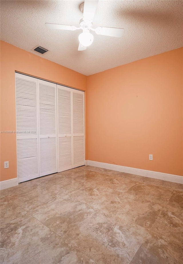 14677 SW 123rd Ave, Miami, FL 33186 - unfurnished bedroom featuring a textured ceiling, a closet, and ceiling fan