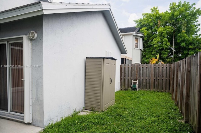 14677 SW 123rd Ave, Miami, FL 33186 - view of property exterior with stucco siding, a fenced backyard, and a shed