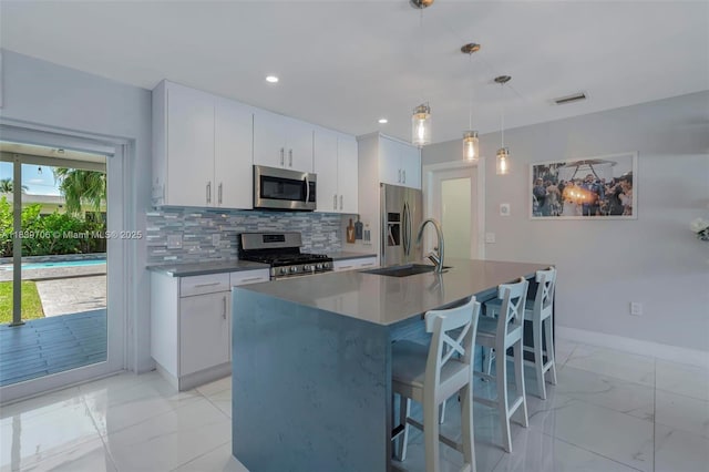11940 NW 33rd St, Sunrise, FL 33323 - kitchen featuring appliances with stainless steel finishes, backsplash, light marble finish floors, white cabinetry, and recessed lighting