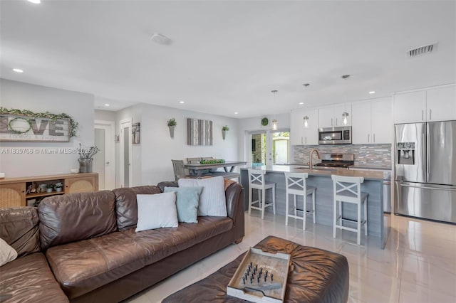 11940 NW 33rd St, Sunrise, FL 33323 - living area with recessed lighting and light tile patterned flooring