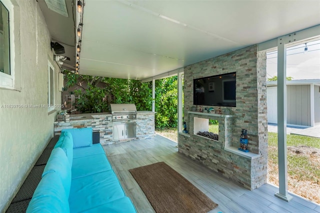 11940 NW 33rd St, Sunrise, FL 33323 - view of patio / terrace with exterior kitchen and an outdoor living space with a fireplace