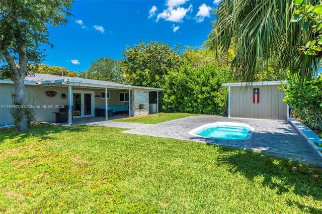 11940 NW 33rd St, Sunrise, FL 33323 - view of grassy yard featuring french doors, a patio area, and an outbuilding