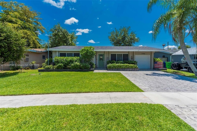 11940 NW 33rd St, Sunrise, FL 33323 - ranch-style house with a garage, decorative driveway, a front yard, and stucco siding