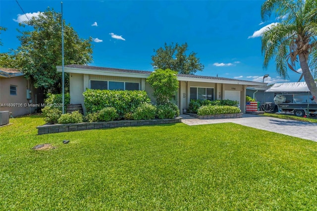 11940 NW 33rd St, Sunrise, FL 33323 - view of front facade featuring stucco siding, a garage, a front lawn, and decorative driveway
