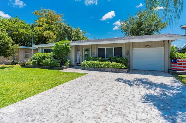 11940 NW 33rd St, Sunrise, FL 33323 - ranch-style home with an attached garage, decorative driveway, a front lawn, and stucco siding