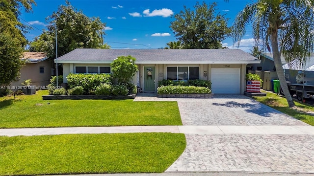 11940 NW 33rd St, Sunrise, FL 33323 - ranch-style house featuring a garage, decorative driveway, a front yard, and stucco siding