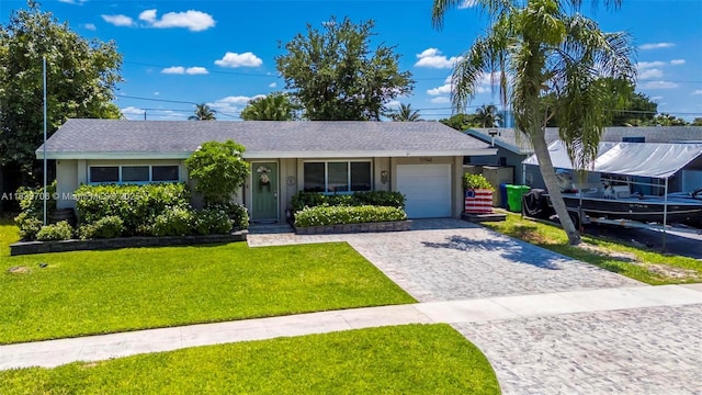 11940 NW 33rd St, Sunrise, FL 33323 - single story home featuring a garage, a front yard, decorative driveway, stucco siding, and a shingled roof