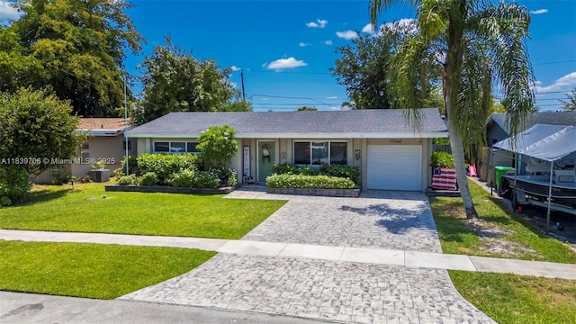 11940 NW 33rd St, Sunrise, FL 33323 - single story home with an attached garage, a front lawn, stucco siding, and decorative driveway