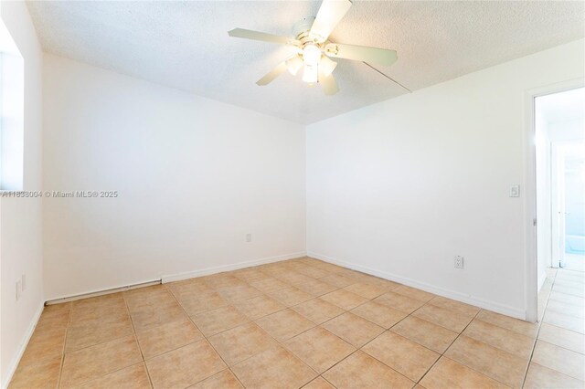 3551 NE 169th St Unit 411, North Miami Beach, FL 33160 - spare room featuring light tile patterned flooring, ceiling fan, and a textured ceiling