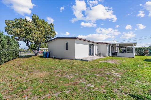11420 SW 44th St, Miami, FL 33165 - rear view of house featuring stucco siding, a sunroom, and a patio area