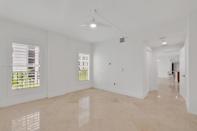 20 Calabria Ave Unit 505, Coral Gables, FL 33134 - empty room featuring a ceiling fan, healthy amount of natural light, and light marble finish floors