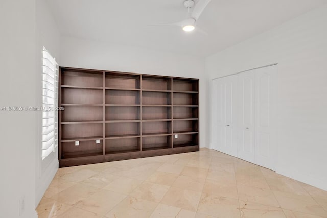 20 Calabria Ave Unit 505, Coral Gables, FL 33134 - unfurnished bedroom featuring marble finish flooring, a closet, and a ceiling fan