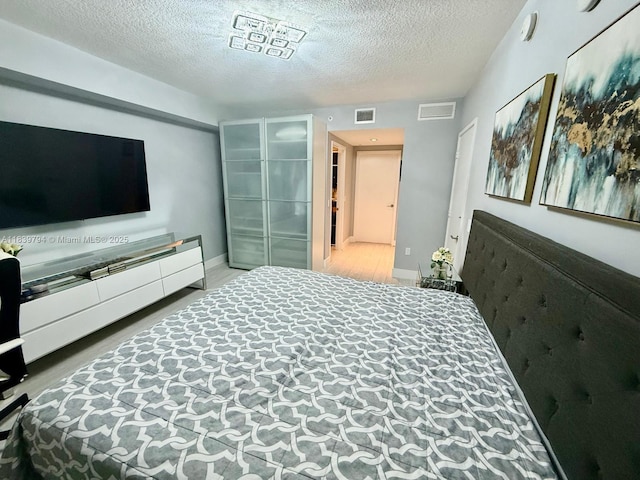 300 Sunny Isles Blvd Unit 4-1806, Sunny Isles Beach, FL 33160 - bedroom featuring a textured ceiling and wood finished floors