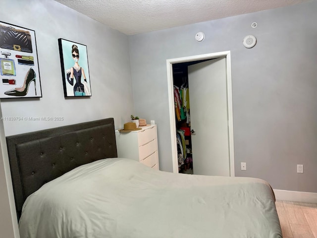 300 Sunny Isles Blvd Unit 4-1806, Sunny Isles Beach, FL 33160 - bedroom with a textured ceiling and wood finished floors