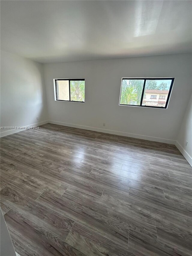4632 NW 90th Ave, Sunrise, FL 33351 - empty room featuring dark wood-type flooring and baseboards