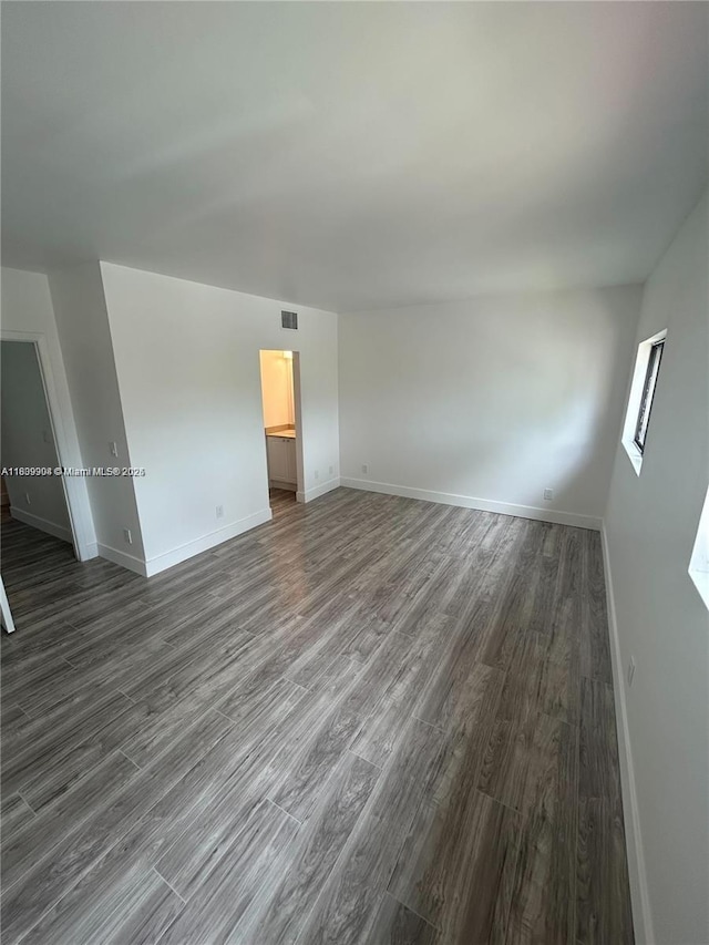 4632 NW 90th Ave, Sunrise, FL 33351 - unfurnished living room with dark wood-type flooring and baseboards