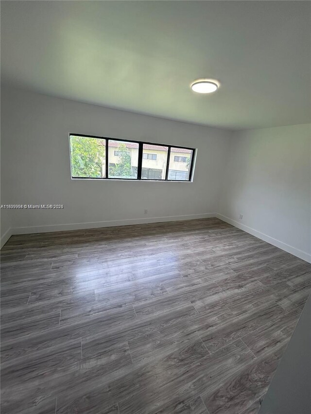 4632 NW 90th Ave, Sunrise, FL 33351 - empty room featuring baseboards and dark wood-type flooring