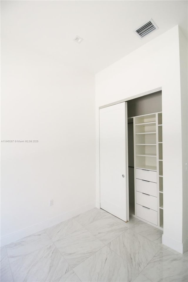 8074 NW 43rd St, Doral, FL 33166 - unfurnished bedroom with light marble finish floors and a closet