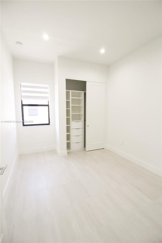 8074 NW 43rd St, Doral, FL 33166 - unfurnished bedroom featuring a closet, recessed lighting, and light tile patterned floors