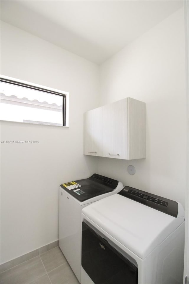 8074 NW 43rd St, Doral, FL 33166 - laundry room featuring cabinet space, separate washer and dryer, and light tile patterned floors
