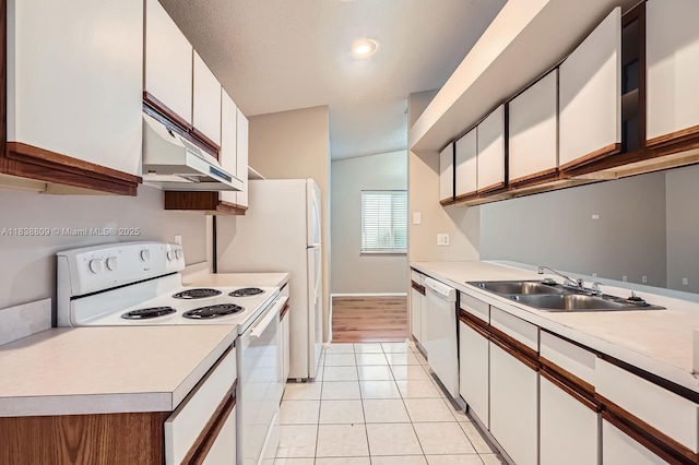 10897 Grandview Ct, Royal Palm Beach, FL 33411 - kitchen with white appliances, under cabinet range hood, light countertops, light tile patterned floors, and white cabinets
