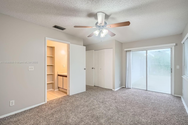 10897 Grandview Ct, Royal Palm Beach, FL 33411 - unfurnished bedroom featuring carpet floors, access to outside, a textured ceiling, ceiling fan, and ensuite bathroom