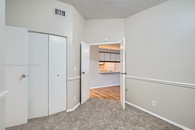 10897 Grandview Ct, Royal Palm Beach, FL 33411 - unfurnished bedroom featuring carpet flooring, a closet, and a textured ceiling
