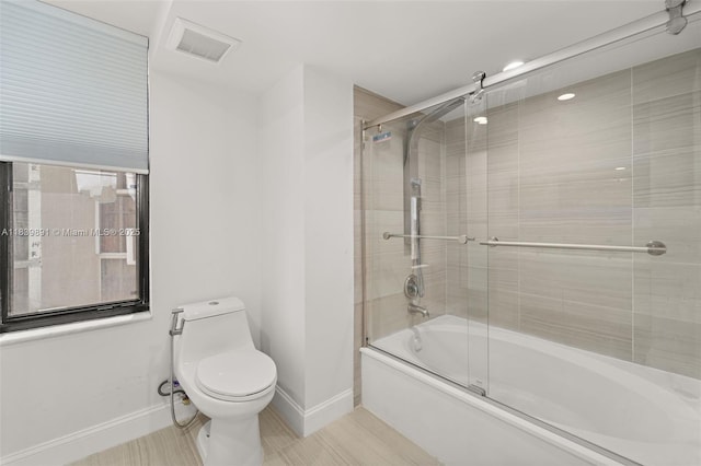 18181 NE 31st Ct Unit 1401, Aventura, FL 33160 - bathroom with baseboards and shower / bath combination with glass door