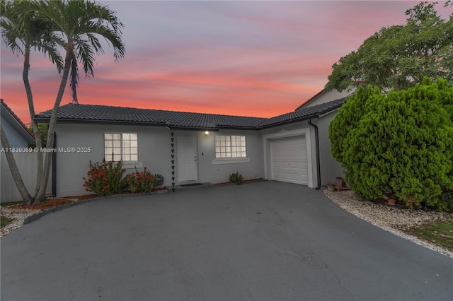 18030 SW 153rd Ct, Miami, FL 33187 - ranch-style house featuring a garage, asphalt driveway, a tile roof, and stucco siding
