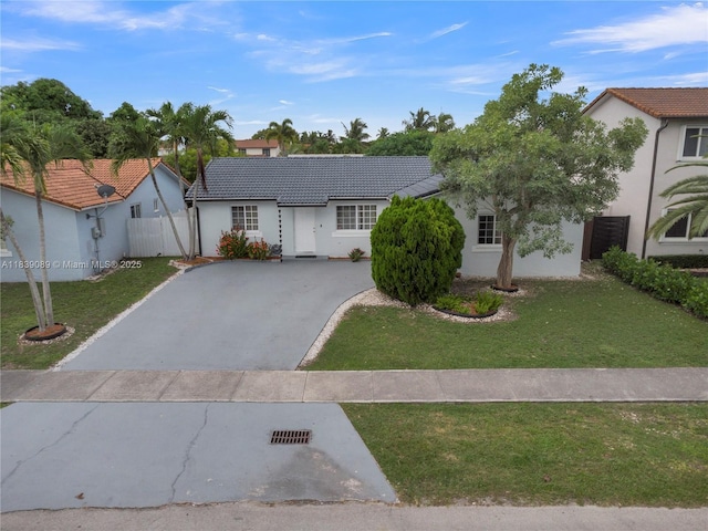 18030 SW 153rd Ct, Miami, FL 33187 - view of front facade with a tiled roof, stucco siding, and driveway