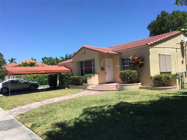 1739 SW 12th Ave, Miami, FL 33129 - mediterranean / spanish-style house featuring a tile roof, stucco siding, and a front lawn