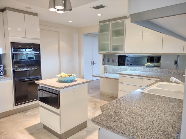 445 Grand Bay Dr Unit 601, Key Biscayne, FL 33149 - kitchen with white cabinetry, a warming drawer, glass insert cabinets, modern cabinets, and recessed lighting