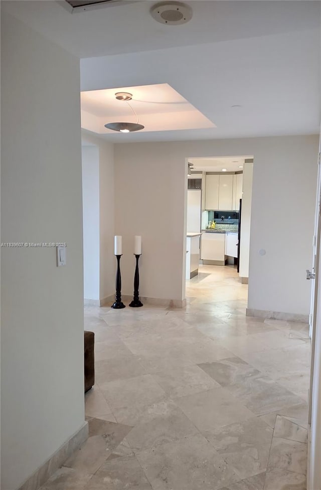 445 Grand Bay Dr Unit 601, Key Biscayne, FL 33149 - hallway featuring a tray ceiling and baseboards