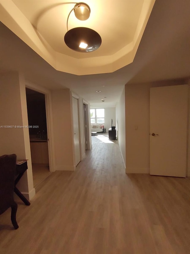 445 Grand Bay Dr Unit 601, Key Biscayne, FL 33149 - hallway featuring a raised ceiling and light wood-style floors