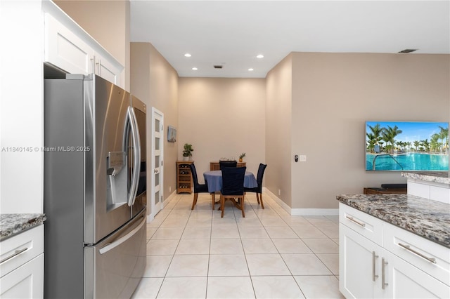 1710 SW 100th Ter, Davie, FL 33324 - kitchen with stainless steel refrigerator with ice dispenser, light tile patterned floors, white cabinets, stone counters, and recessed lighting