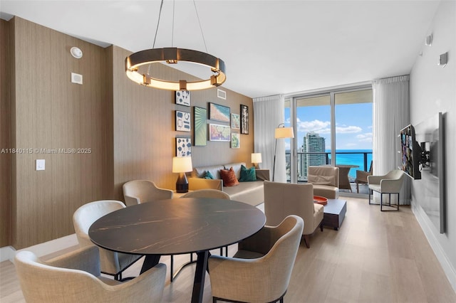 4111 S Ocean Dr Unit 2906, Hollywood, FL 33019 - dining space featuring expansive windows, light wood-style flooring, and a water view