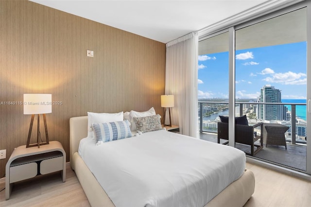 4111 S Ocean Dr Unit 2906, Hollywood, FL 33019 - bedroom featuring light wood-style flooring, access to exterior, a water view, and floor to ceiling windows