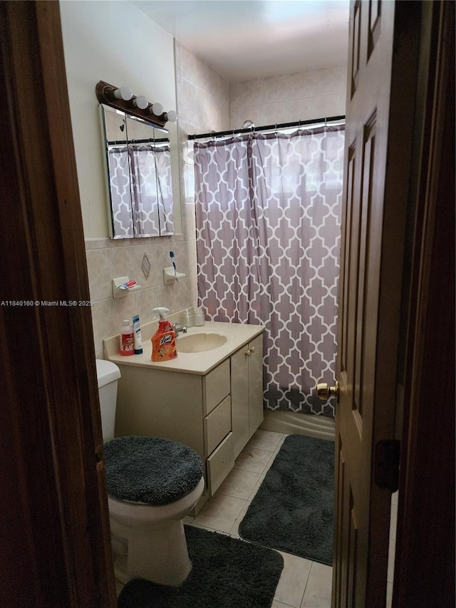 850 NE 172nd Ter, North Miami Beach, FL 33162 - bathroom with vanity, tile patterned flooring, tile walls, and a shower with shower curtain