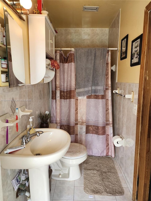 850 NE 172nd Ter, North Miami Beach, FL 33162 - full bathroom featuring tile walls, tile patterned flooring, and tiled shower